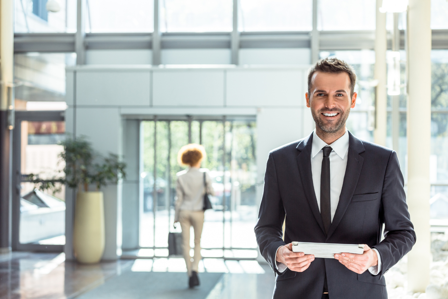 An image of a happy hotelier who has Cloud Technology for Hotels